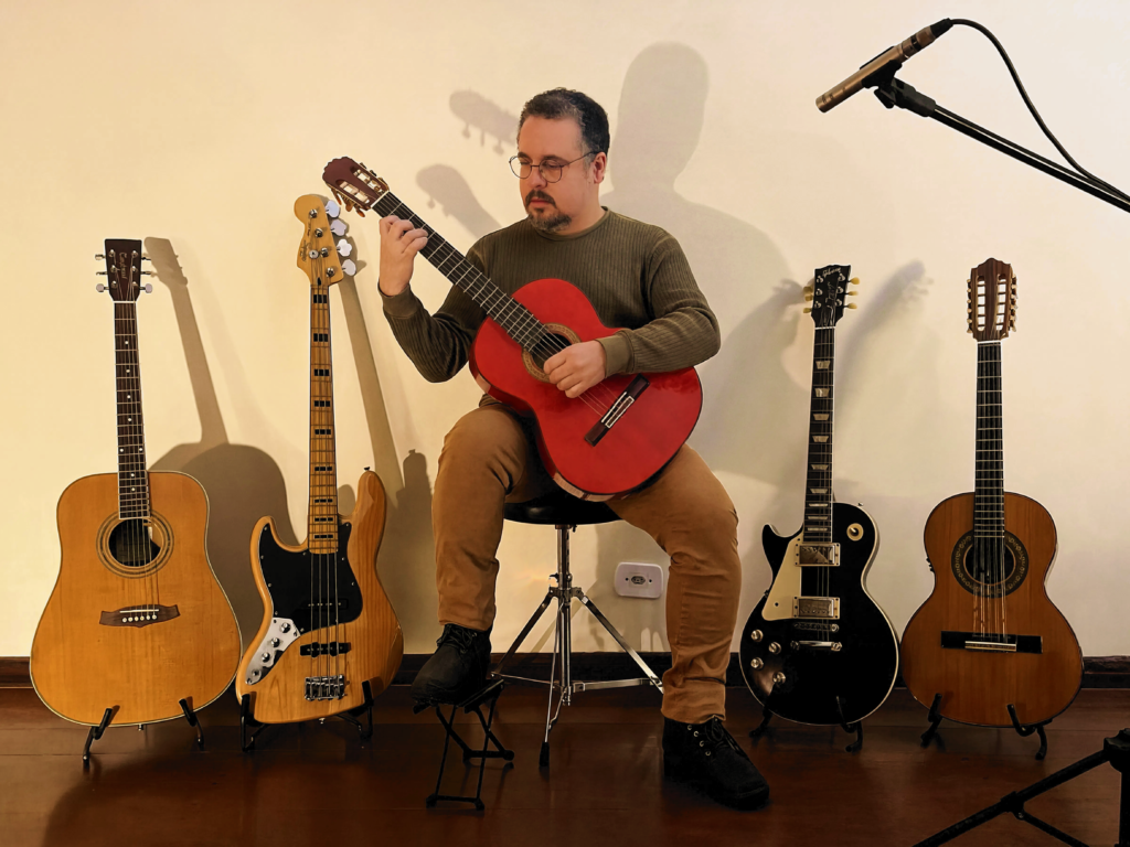 Wendel playing acoustic guitar